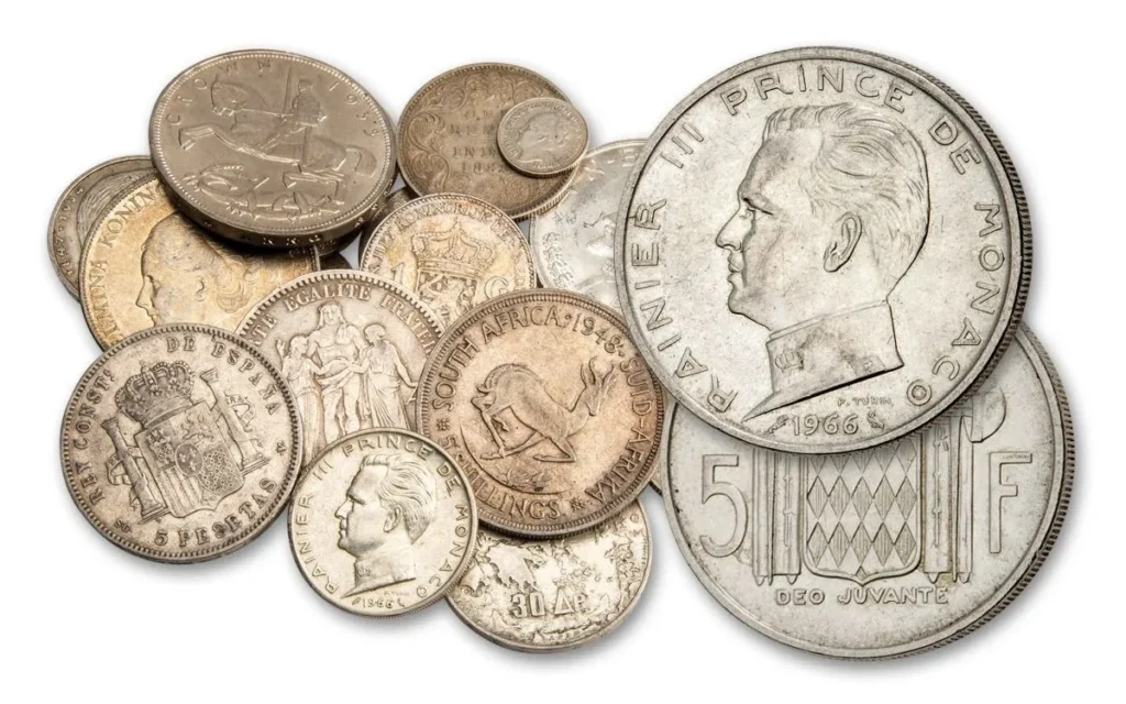 Foreign coins commonly found in the U.S. including Spanish Reales, Canadian cents, and Mexican pesos